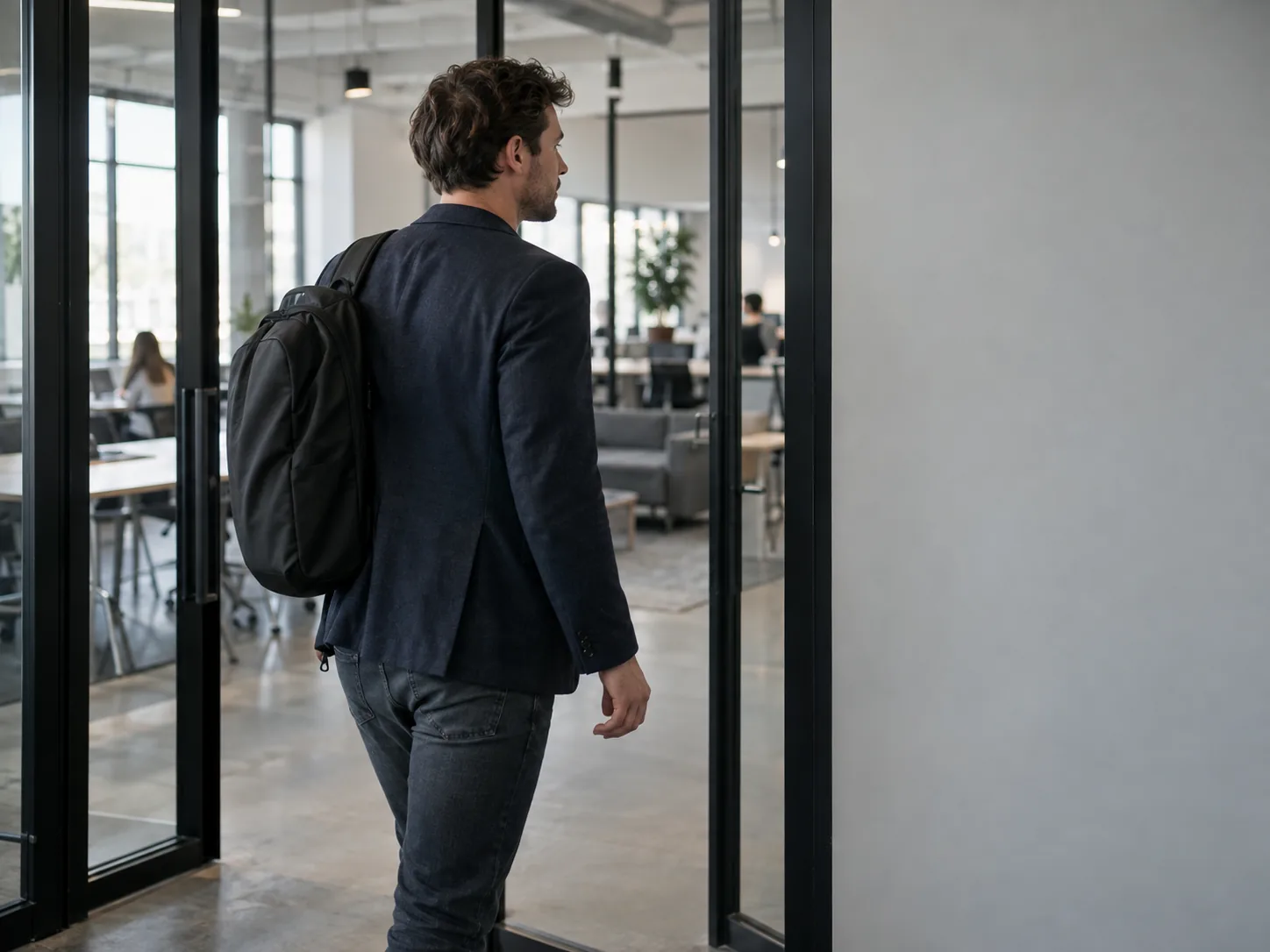 A member walks through the glass entrance of a co-working floor.